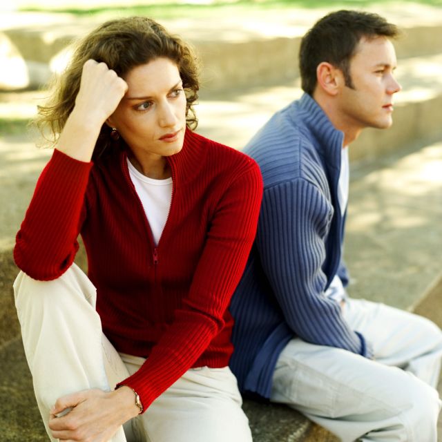 Young Couple Seated Back To Back (Demo)